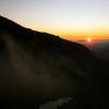 The fog lifts like a blanket off the peaks