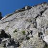 Looking up at the steep, blank face of Hallets above us