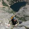 Mark pulling over the final 5.9 roof, hanging over 1500ft of empty air