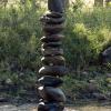 A rock tower that somebody built in the middle of the river