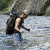 Mark wades through the deep, fast moving water, this was tricky with a pack on