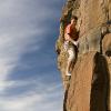 A climber leads up the route to our left