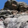 Mark happily sits below a giant rock butt