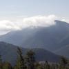 A lifting cloud deck enshrouds the foothills