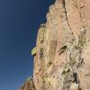Looking up at the pink basalt cliffs