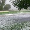 Hail took the leaves off the tree and filled the street