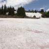 The trail moves over a snow field