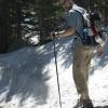 Mark hiking on a big pile of snow