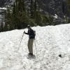 Liz carefully walks down the steep snow field