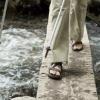 Liz crosses on a small plank bridge