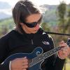 Briana plays mandolin in the rocky mountains