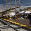 The outdoor booths of the market are lined up next to the railroad