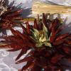 Cross decorations made from chilli's and thistles 