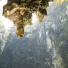 Limestone formations hang above the lagoon