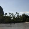 Climbers hike home across Railay East bay at low tide