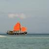 A Junk cruises by in the evening