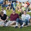 The family hangs out at the park in the evening